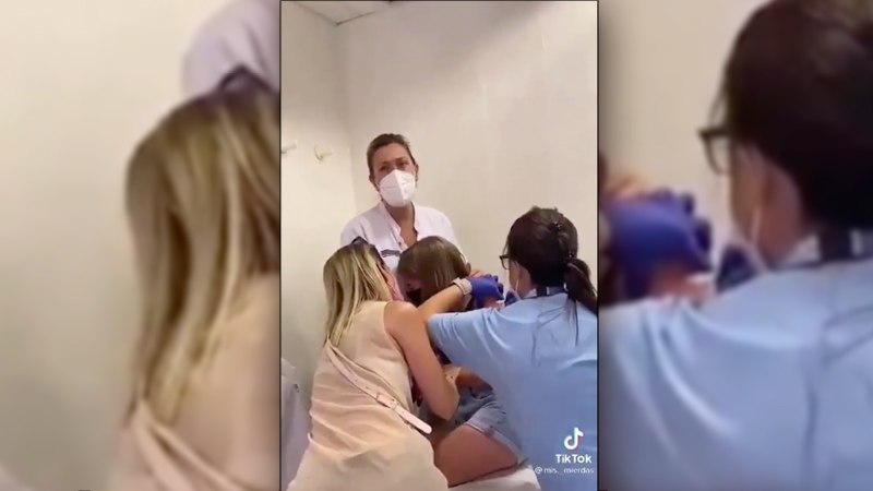 Infuriating Video: Child Cries As She’s Held Down, Injected With Covid Vax Against Her Will