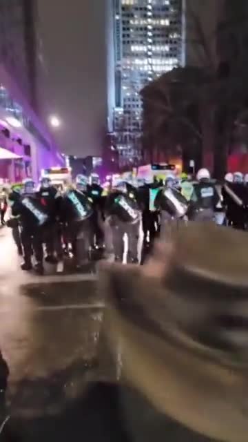 Montreal, Quebec, Canada confront riot police while protesting in the streets.