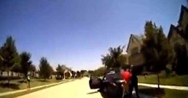 Police officer arrests a man for rolling his car window up and pepper spray his father for filming the arrest, as another officer tackles the man to the ground [VIDEO]
