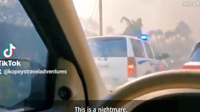 ‘We’re All Trapped Here…They’re Blocking Off All Exits’: Driver Furious as Police Vehicle Speeds Past Him to ‘Trap’ Residents Fleeing Lahaina Wildfires